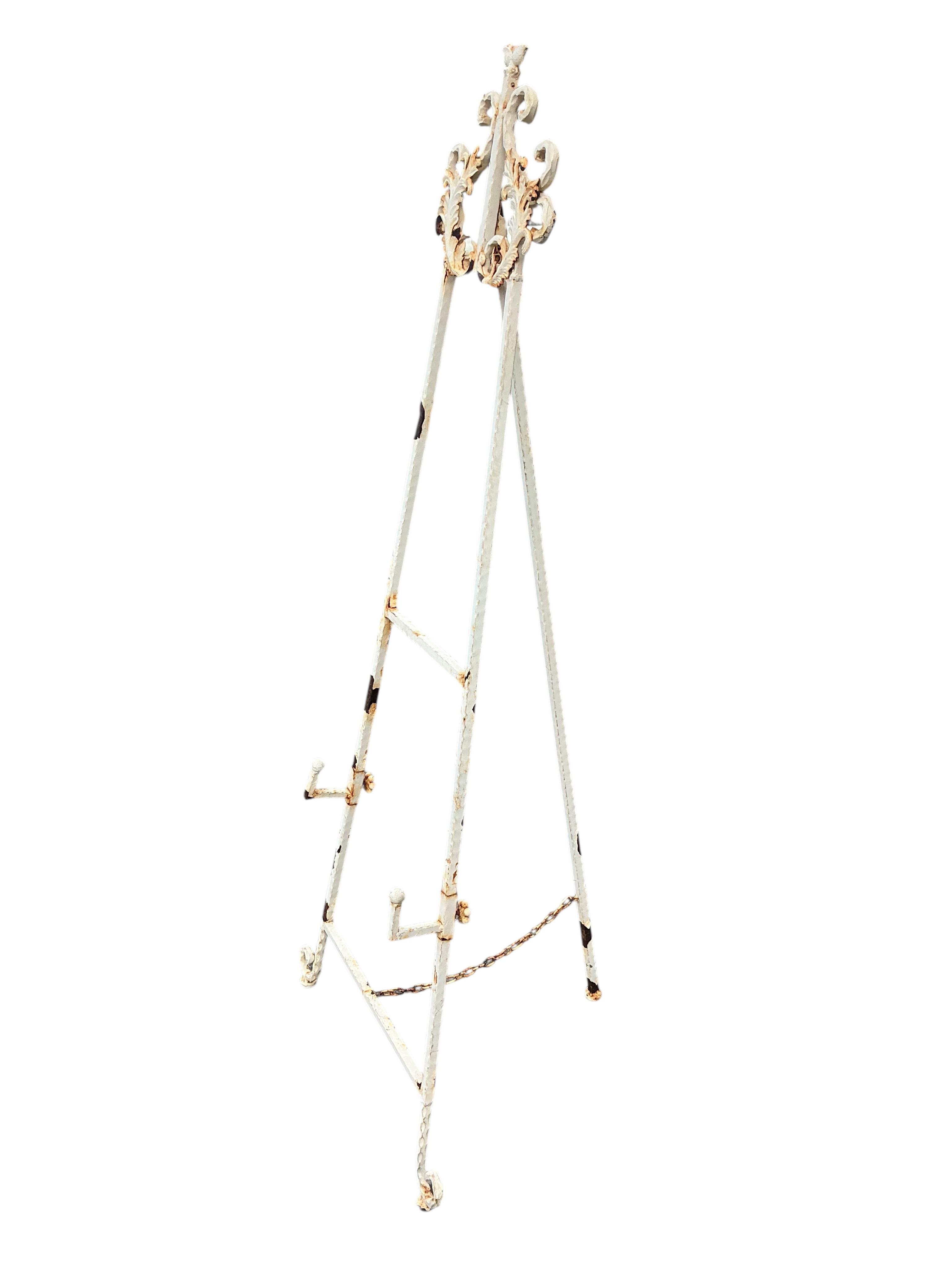 A painted metal garden easel together with two Victorian style cast metal bench ends
